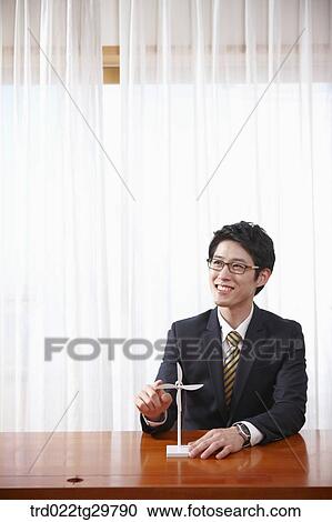 Stock Image - man touching pin wheels. Fotosearch