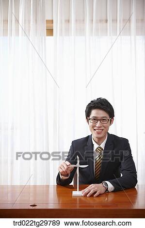 Stock Photo - man touching pin wheels. Fotosearch