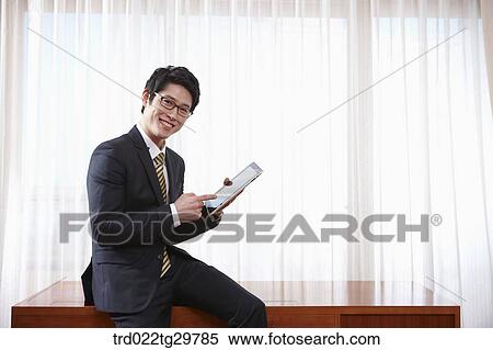 Stock Photography - man touching tablet pc. Fotosearch