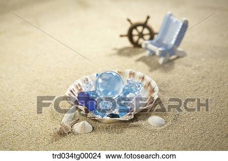 sea shells and miniature of summer item on the sand View Large Photo Image Picture - sea shells and miniature of summer item on the sand. Fotosearch