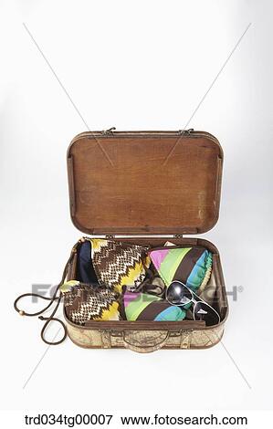 Stock Photo - swimsuit in luggage bag. Fotosearch