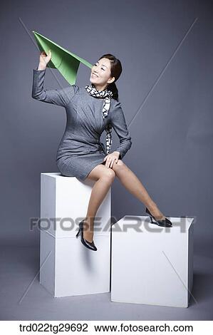 woman flying paper airplane View Large Photo Image Stock Image - woman flying paper airplane. Fotosearch