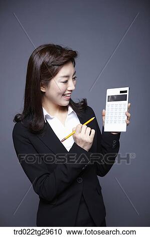 woman holding calculation View Large Photo Image Stock Image - woman holding calculation. Fotosearch