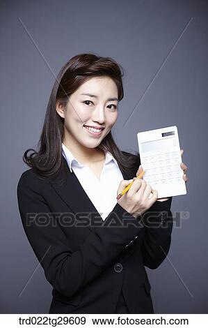 woman holding calculation View Large Photo Image Stock Photo - woman holding calculation. Fotosearch