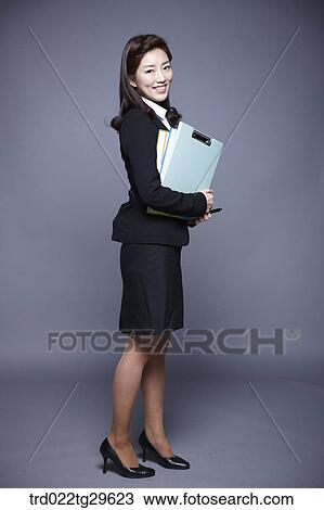 Stock Image - woman holding files. Fotosearch