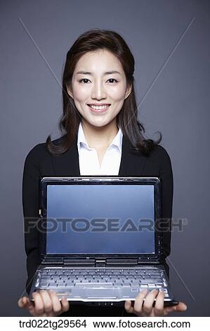 woman holding laptop View Large Photo Image Picture - woman holding laptop. Fotosearch