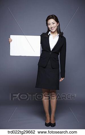 Stock Image - woman holding paper board. Fotosearch