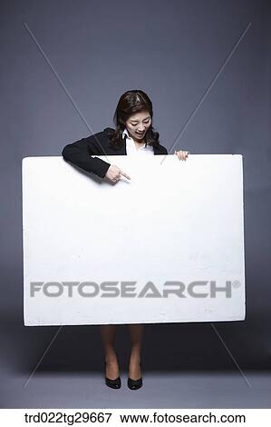 woman holding paper board View Large Photo Image Stock Photo - woman holding paper board. Fotosearch