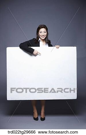 Stock Photograph - woman holding paper board. Fotosearch