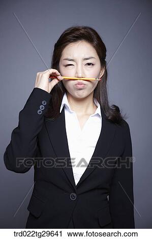Stock Image - woman holding pencil. Fotosearch