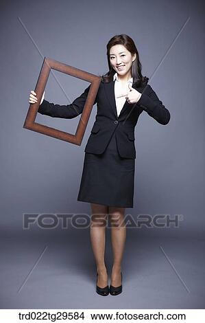 woman holding picture frame View Large Photo Image Picture - woman holding picture frame. Fotosearch