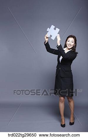 woman holding puzzle piece View Large Photo Image Stock Image - woman holding puzzle piece. Fotosearch