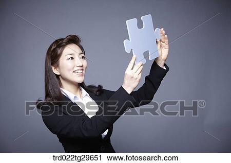 woman holding puzzle piece View Large Photo Image Stock Image - woman holding puzzle piece. Fotosearch