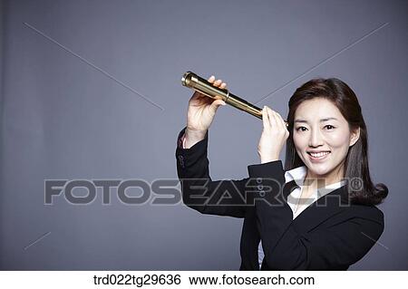 Stock Photograph - woman holding telescope. Fotosearch