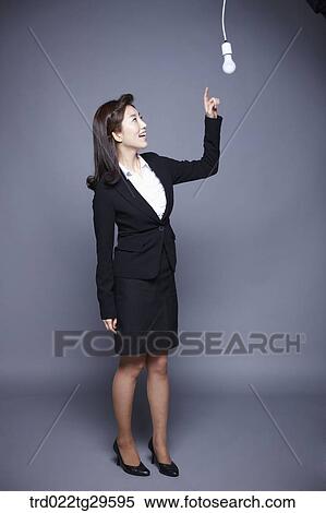 woman point at light bulb View Large Photo Image Stock Photography - woman point at light bulb. Fotosearch