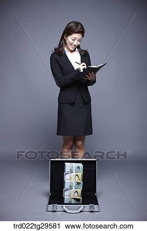 woman smiling seeing stack of money View Large Photo Image Stock Image - woman smiling seeing stack of money. Fotosearch