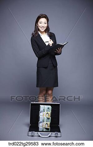 woman smiling seeing stack of money View Large Photo Image Stock Image - woman smiling seeing stack of money. Fotosearch