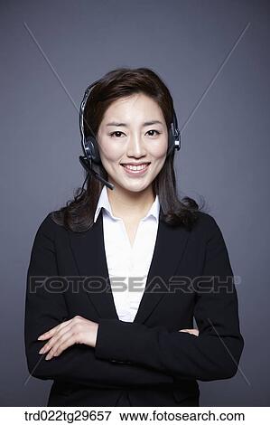 Stock Photo - woman wearing headset. Fotosearch