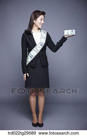 Stock Photo - woman wearing money band and holding money. Fotosearch