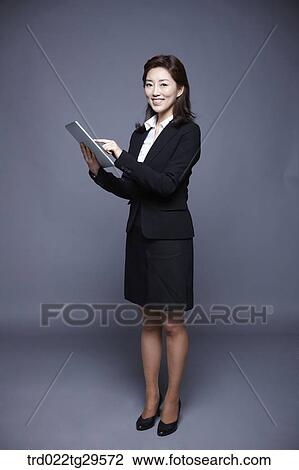 Stock Image - woman working by using tablet pc. Fotosearch
