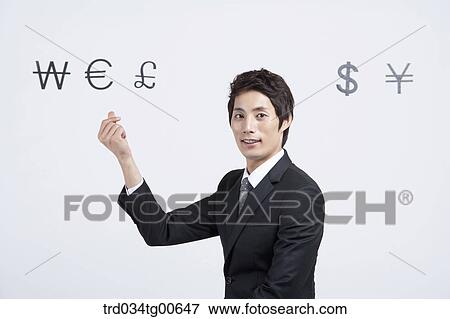A man coming up an idea with foreign currency around View Large Photo Image Stock Photo - A man coming up an idea with foreign currency around. Fotosearch