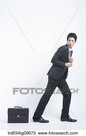 A man dragging the suitcase with twisted wire View Large Photo Image Stock Image - A man dragging the suitcase with twisted wire. Fotosearch