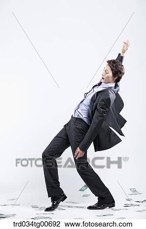 A man hard to stand and flying money View Large Photo Image Stock Image - A man hard to stand and flying money. Fotosearch