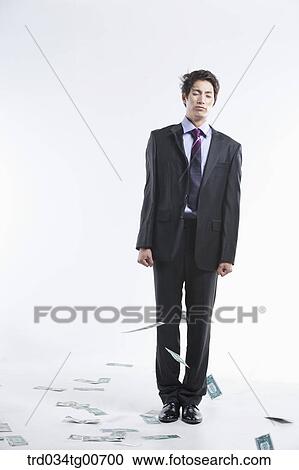 A man hard to stand and flying money View Large Photo Image Stock Image - A man hard to stand and flying money. Fotosearch