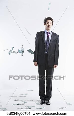 A man hard to stand and flying money View Large Photo Image Stock Image - A man hard to stand and flying money. Fotosearch