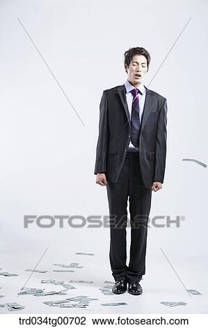 A man hard to stand and flying money View Large Photo Image Stock Image - A man hard to stand and flying money. Fotosearch