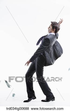 A man hard to stand and flying money View Large Photo Image Stock Photo - A man hard to stand and flying money. Fotosearch