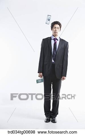 A man hard to stand and flying money View Large Photo Image Stock Photo - A man hard to stand and flying money. Fotosearch