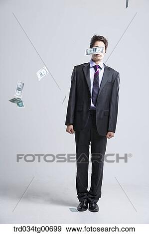A man hard to stand and flying money View Large Photo Image Stock Photo - A man hard to stand and flying money. Fotosearch