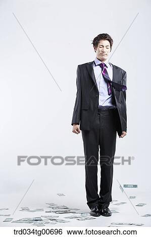 A man hard to stand and flying money View Large Photo Image Stock Photograph - A man hard to stand and flying money. Fotosearch