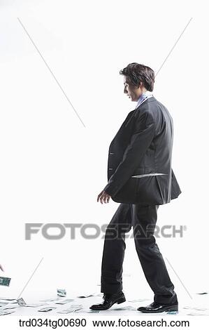 A man hard to walk forward and flying money View Large Photo Image Stock Image - A man hard to walk forward and flying money. Fotosearch