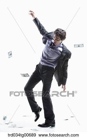 A man hard to walk forward and flying money View Large Photo Image Stock Photo - A man hard to walk forward and flying money. Fotosearch