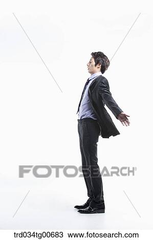 Stock Image - A man hard to walk forward hit by the wind. Fotosearch