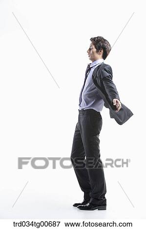 Stock Photo - A man hard to walk forward hit by the wind. Fotosearch