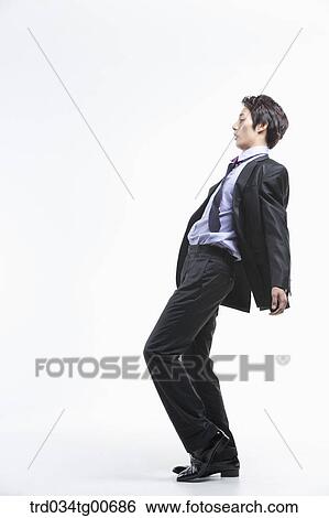 A man hard to walk forward hit by the wind View Large Photo Image Stock Photograph - A man hard to walk forward hit by the wind. Fotosearch