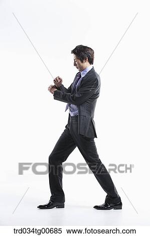 A man hard to walk forward hit by the wind View Large Photo Image Stock Photography - A man hard to walk forward hit by the wind. Fotosearch