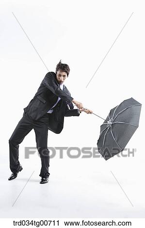 A Man Hit By The Strong Wind With An Umbrella Inside Out Stock Image Trd034tg00711 Fotosearch