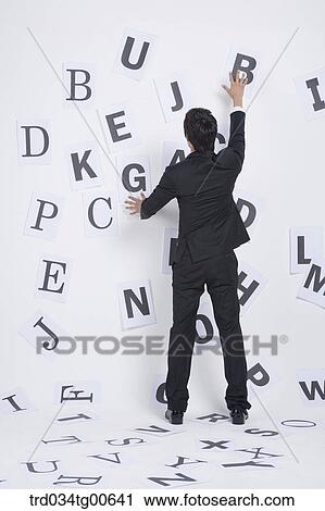 A man in front of the English letter written papers View Large Photo Image Stock Image - A man in front of the English letter written papers. Fotosearch