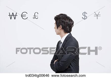 A man looking back with foreign currency around View Large Photo Image Stock Photograph - A man looking back with foreign currency around. Fotosearch