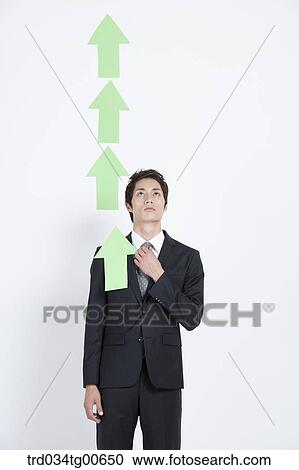 A man looking upon rising green arrows View Large Photo Image Stock Image - A man looking upon rising green arrows. Fotosearch