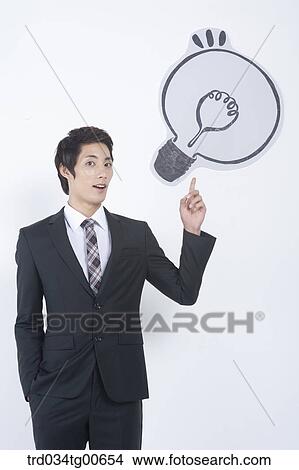 A man pointing the bulb View Large Photo Image Picture - A man pointing the bulb. Fotosearch