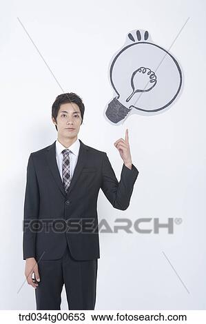 A man pointing the bulb View Large Photo Image Stock Image - A man pointing the bulb. Fotosearch