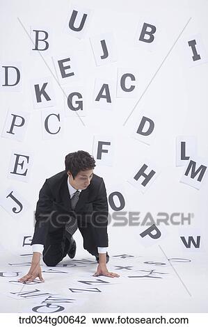 Stock Image - A man sitting down on the English letter written papers . Fotosearch