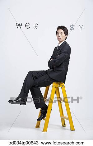 A man sitting on yellow ladder with foreign currency around View Large Photo Image Stock Image - A man sitting on yellow ladder with foreign currency around. Fotosearch
