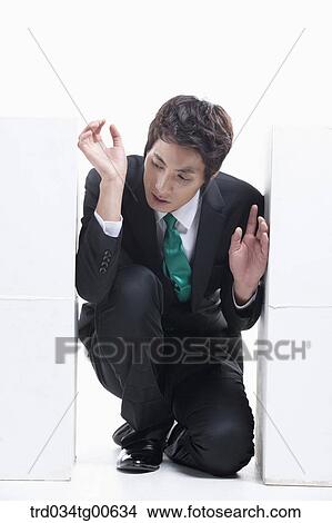 Picture - A man stuck between the piled boxes. Fotosearch