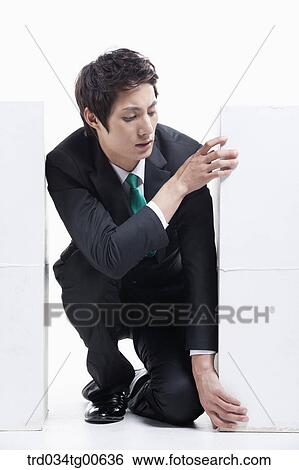 A man stuck between the piled boxes View Large Photo Image Stock Photograph - A man stuck between the piled boxes. Fotosearch